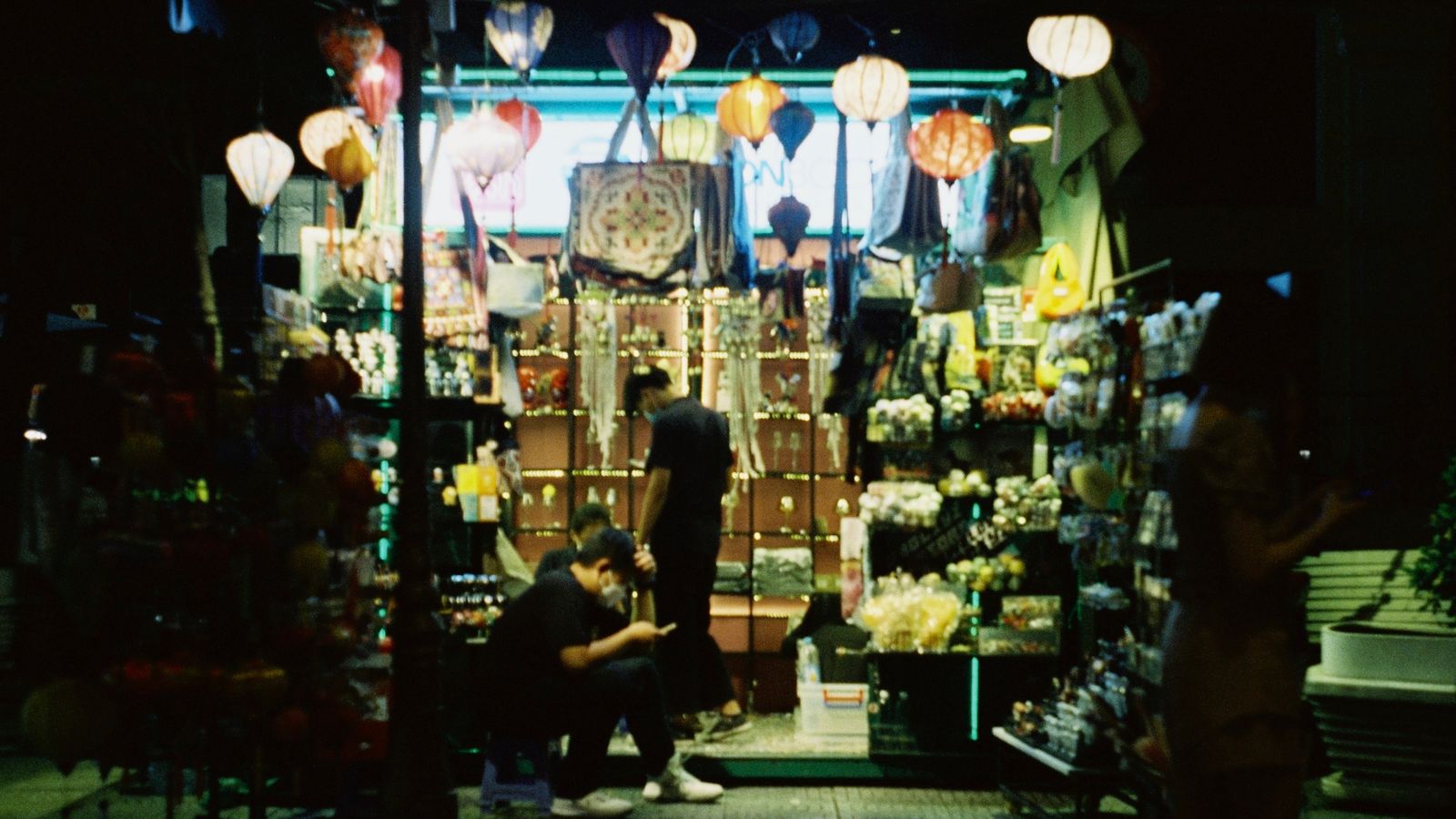 Illuminated market stall at night with hanging lanterns — the kind of evening atmosphere Grand World Phú Quốc creates along its waterfront