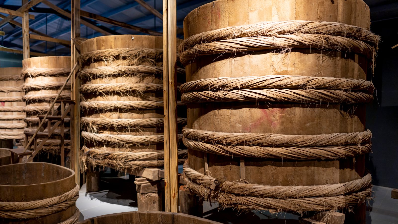 Rows of large wooden barrels used to ferment fish sauce — the traditional method still used by Phú Quốc factories